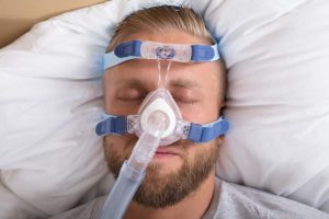 Image showing sleeping man with nasal CPAP machine