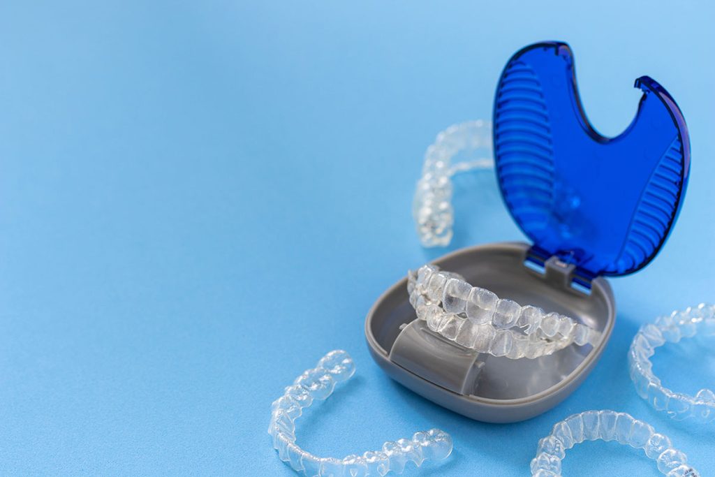 An Invisalign® clear braces set with multiple aligners