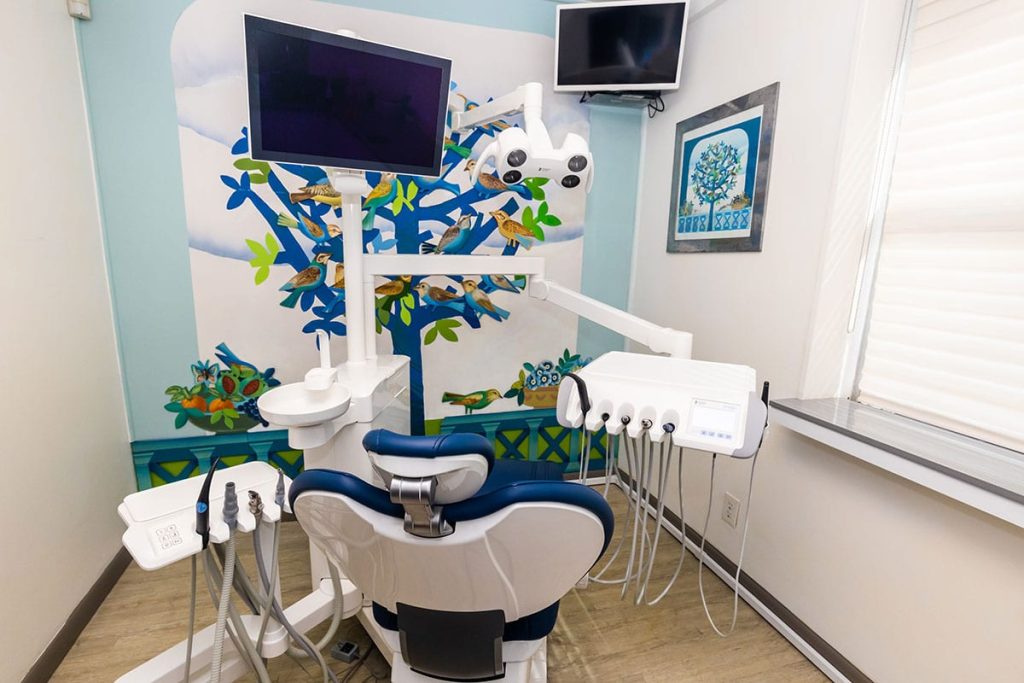 Dental chair with dental equipment in the exam room.