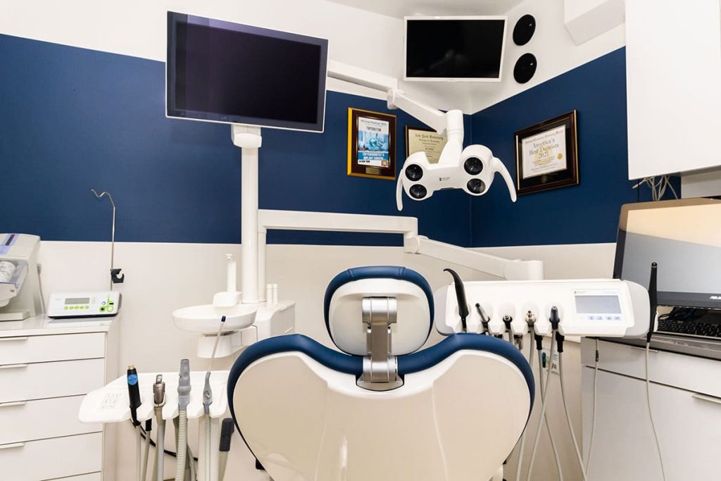 Dental exam room with dental chair and other dental equipment.