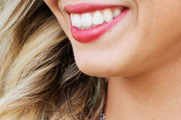 Closeup of womans lower face smiling.