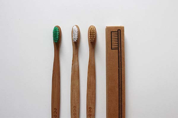 An assortment of toothbrushes with wooden handles.