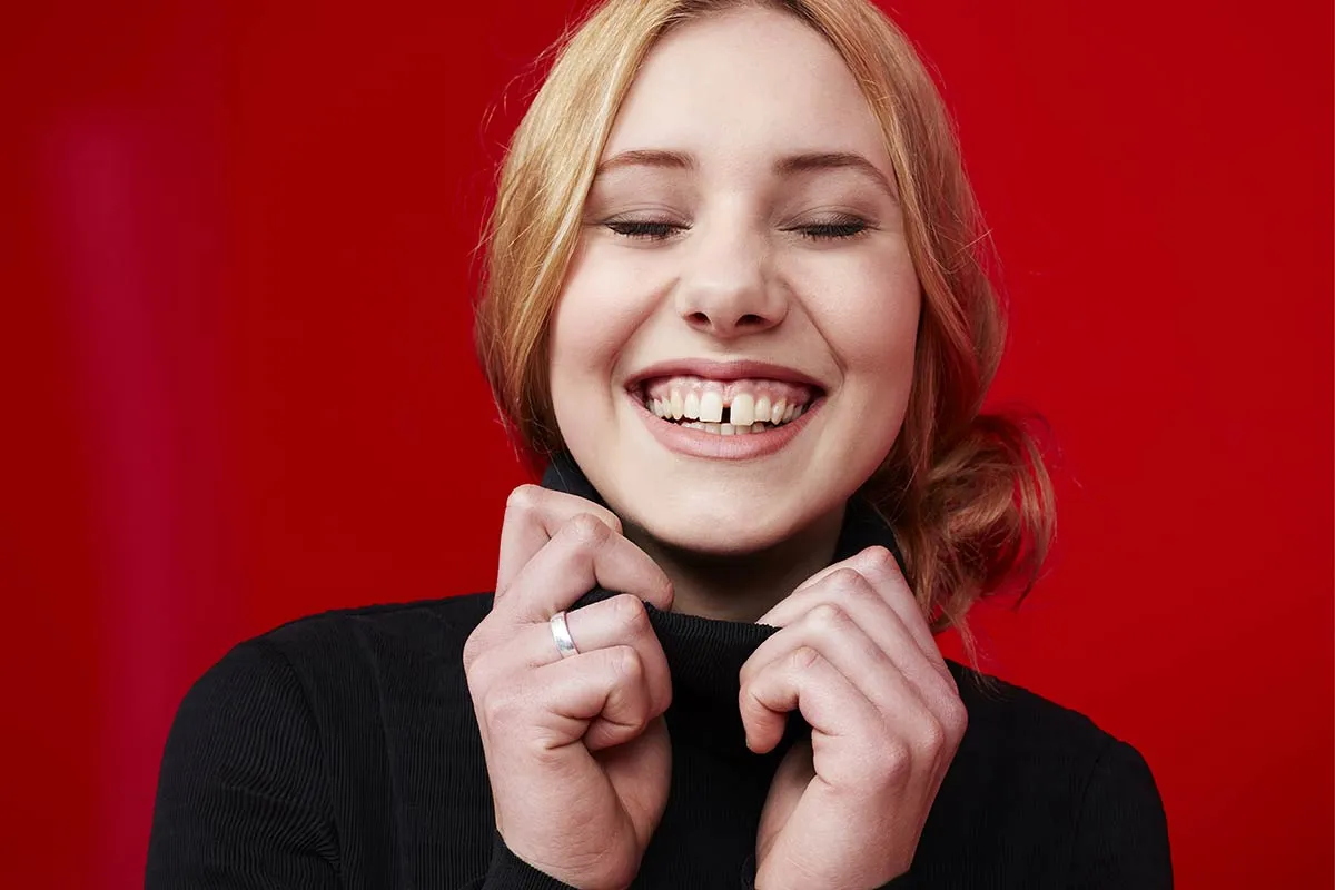 Woman smiling with gaps between teeth.